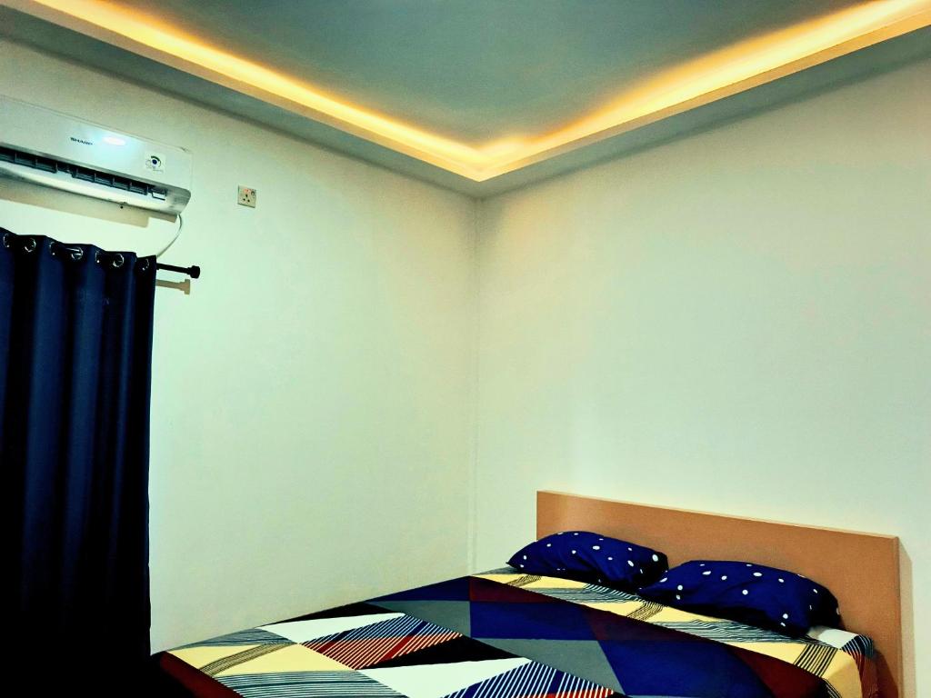 Ένα ή περισσότερα κρεβάτια σε δωμάτιο στο Casa Bella Homestay