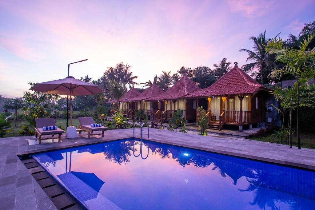 a villa with a swimming pool and a resort at Pondok Tegal Tunon Villa Ubud Bali in Ubud