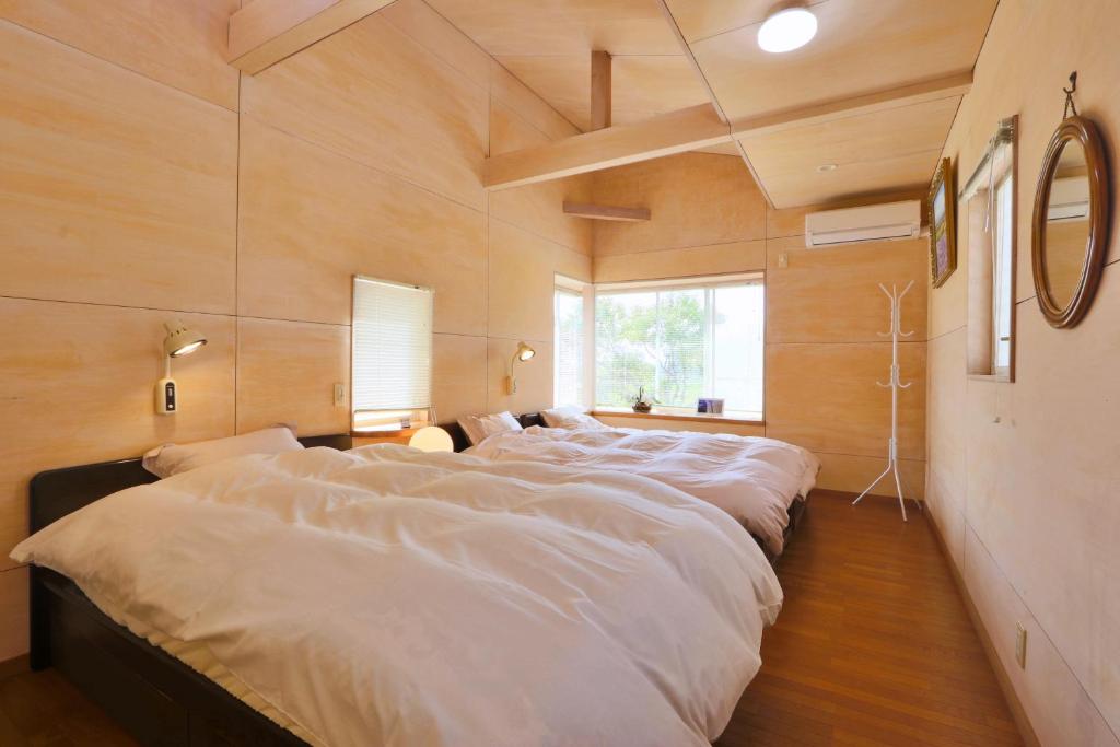 Postel nebo postele na pokoji v ubytování ペスカドール