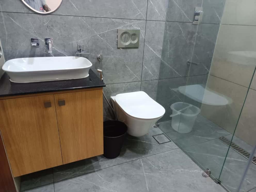 a bathroom with a sink and a toilet at Oceanus Retreat in Mayyanād