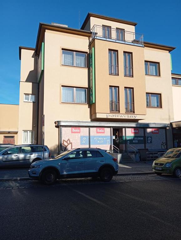 a blue car parked in front of a building at Penzion Růže in Humpolec