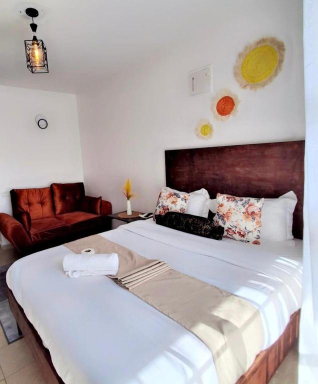 a bedroom with two beds and a couch at Eston Haven in Ruaka