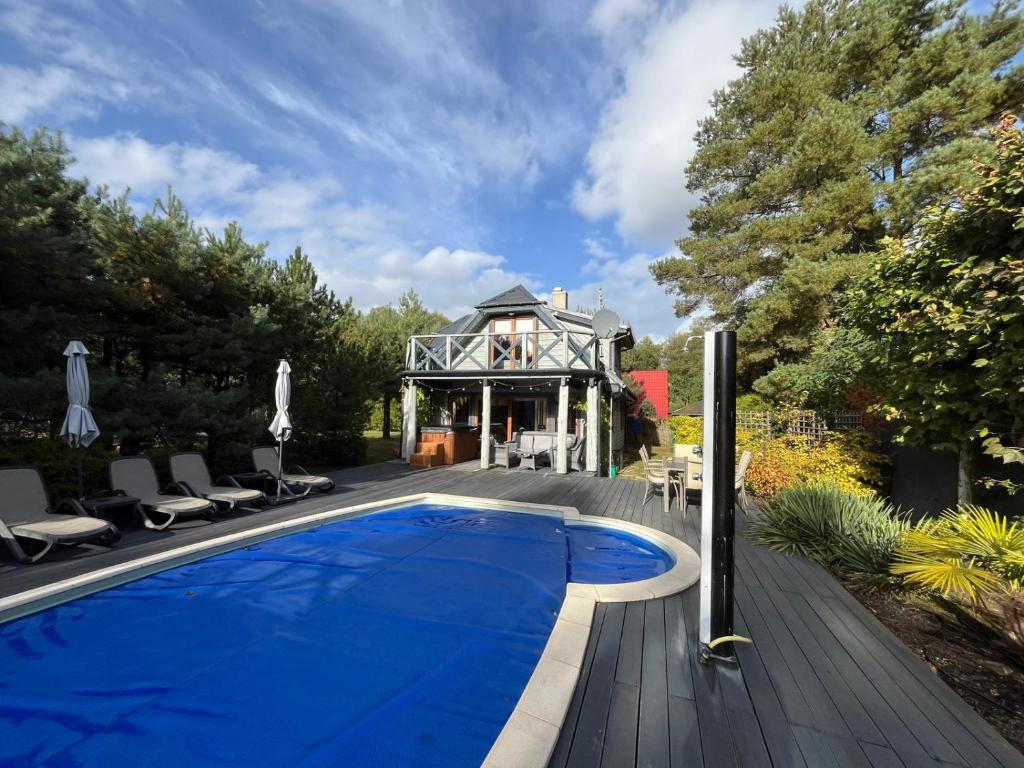 a swimming pool in front of a house at Harmony Spa Matyldów in Matyldów