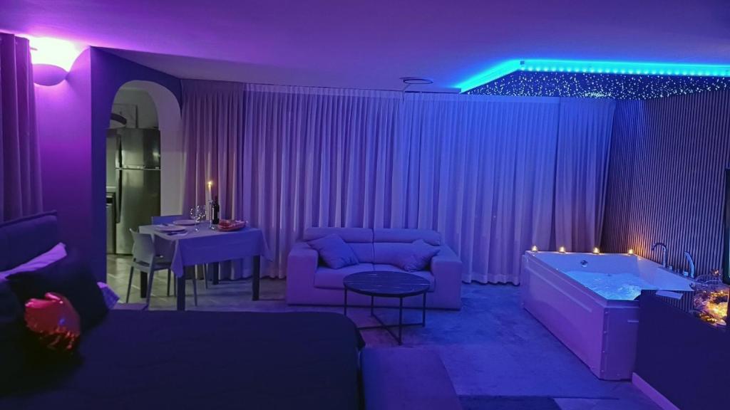 a purple living room with a couch and a tub at Luxury Suite Quartu in Quartu SantʼElena