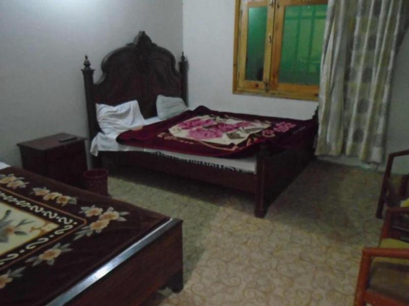 a small bedroom with a bed and a window at Star Rise Hotel in Naran