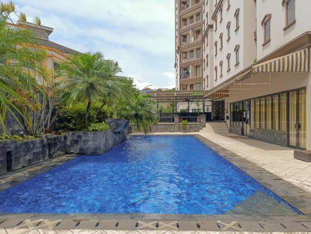 a swimming pool in the middle of a building at 2BR Apartment Majesty W Pool in Bandung