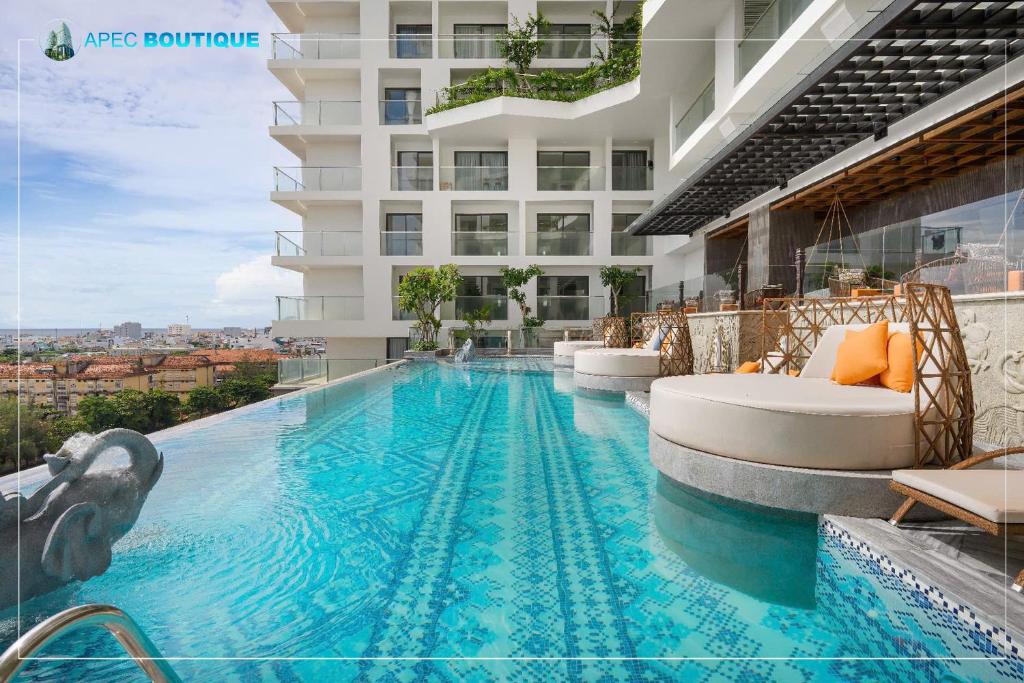 a swimming pool on the side of a building at Mandala Wins Hotel Phú Yên in Phước Hậu