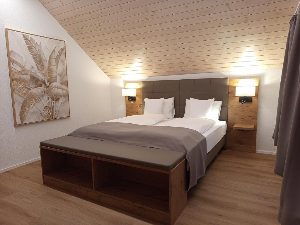a bedroom with a large bed with white pillows at Gästehaus Rossfall 424 - Self-Check-in in Urnäsch