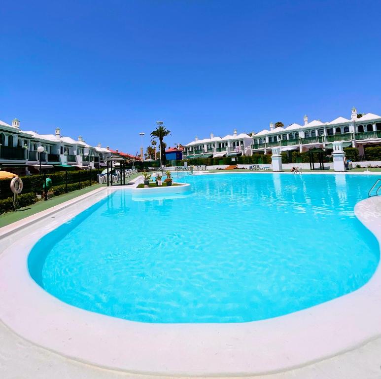 a large pool with blue water in a resort at Paradise Dreams in Maspalomas