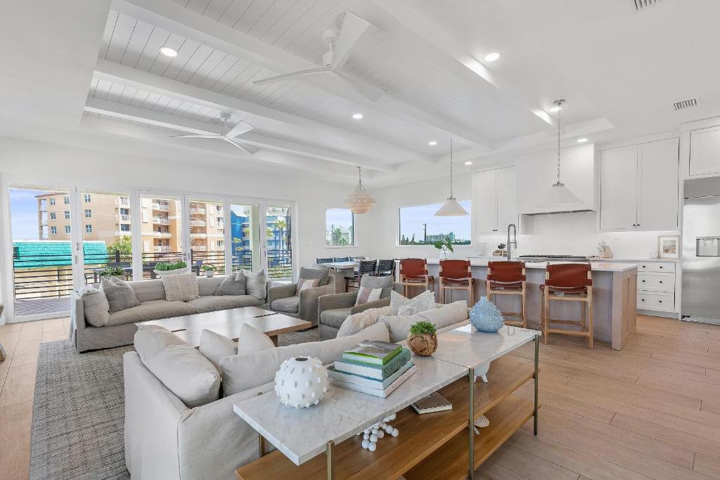a living room with a couch and a table at Sea View Play in New Smyrna Beach