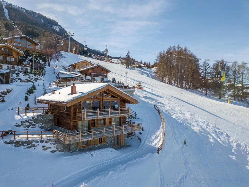 a log cabin in the snow on a ski slope at Oak Tree Chalet - on the ski slope - luxury! in Nendaz