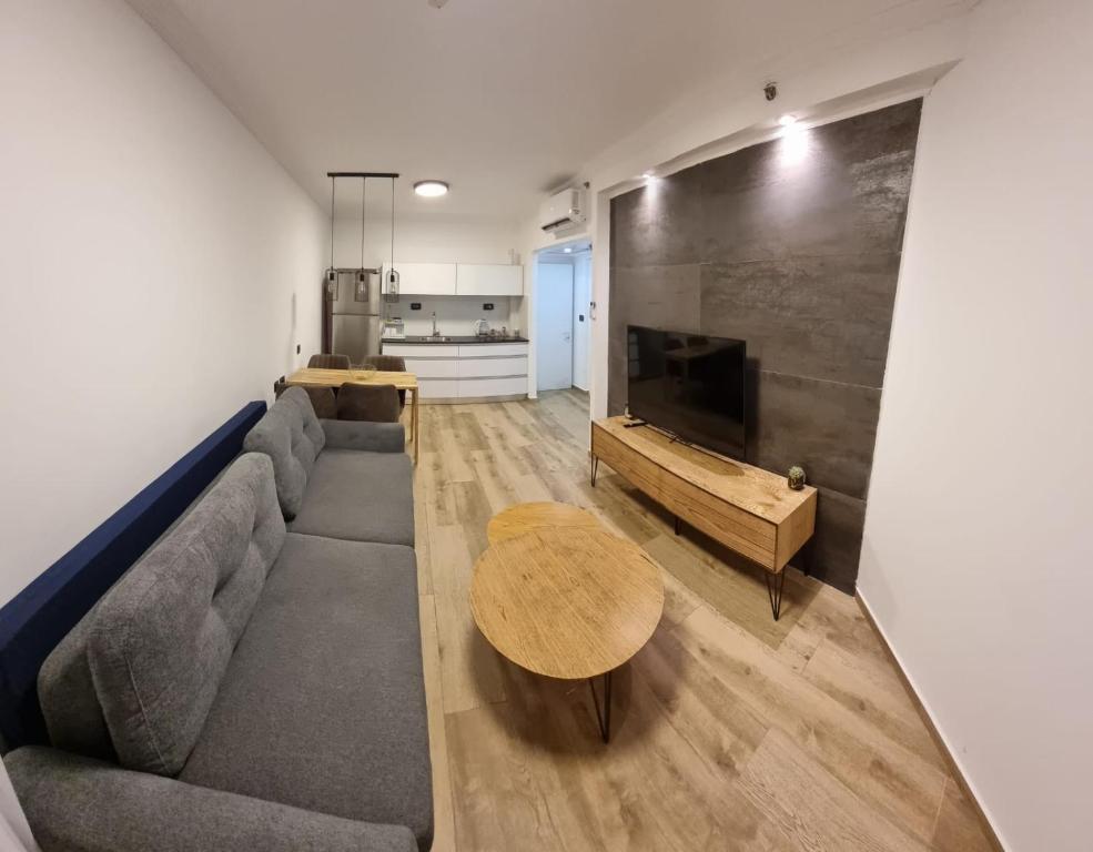 a living room with a couch and a table at Kings Apartments in Tiberias