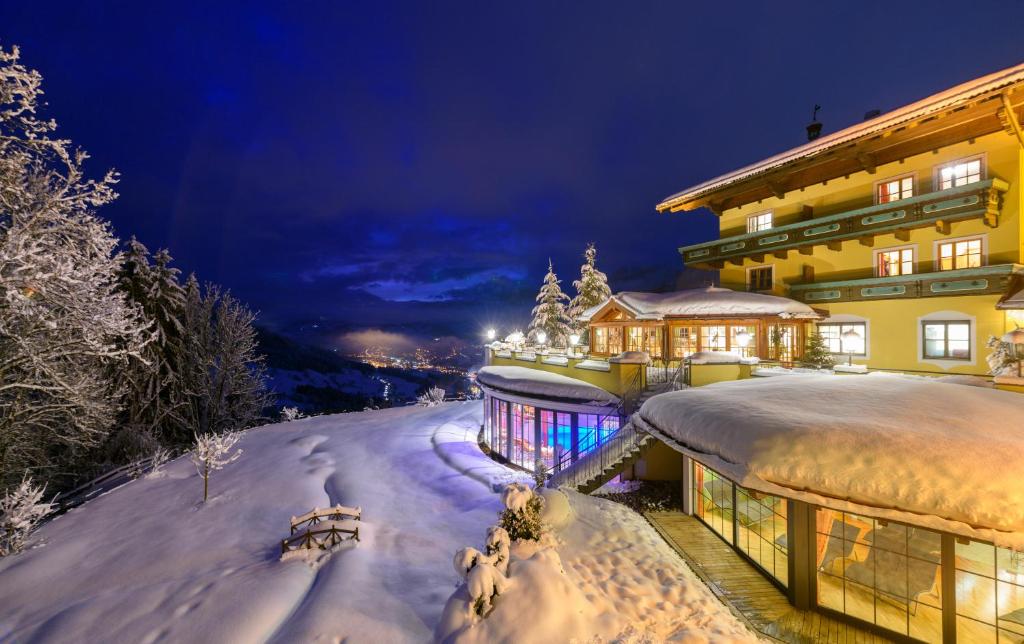 a building covered in snow at night at Appartements Gut Berg in Sankt Johann im Pongau
