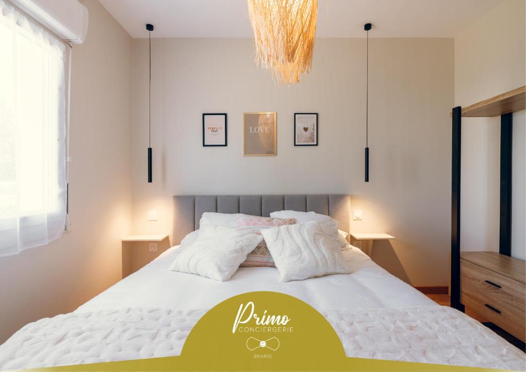 a bedroom with a bed with white sheets and a chandelier at L'élegant, climatisé et rénové - Appart'hôtel Chez MV in La Ferté-Gaucher