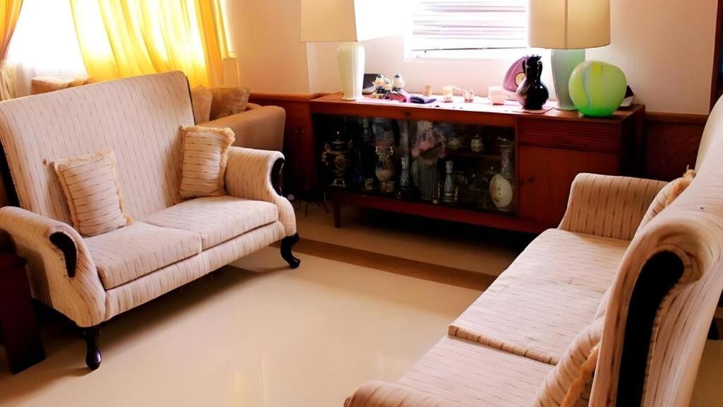 a living room with two chairs and a table at The Niwasa Resident in Nuwara Eliya