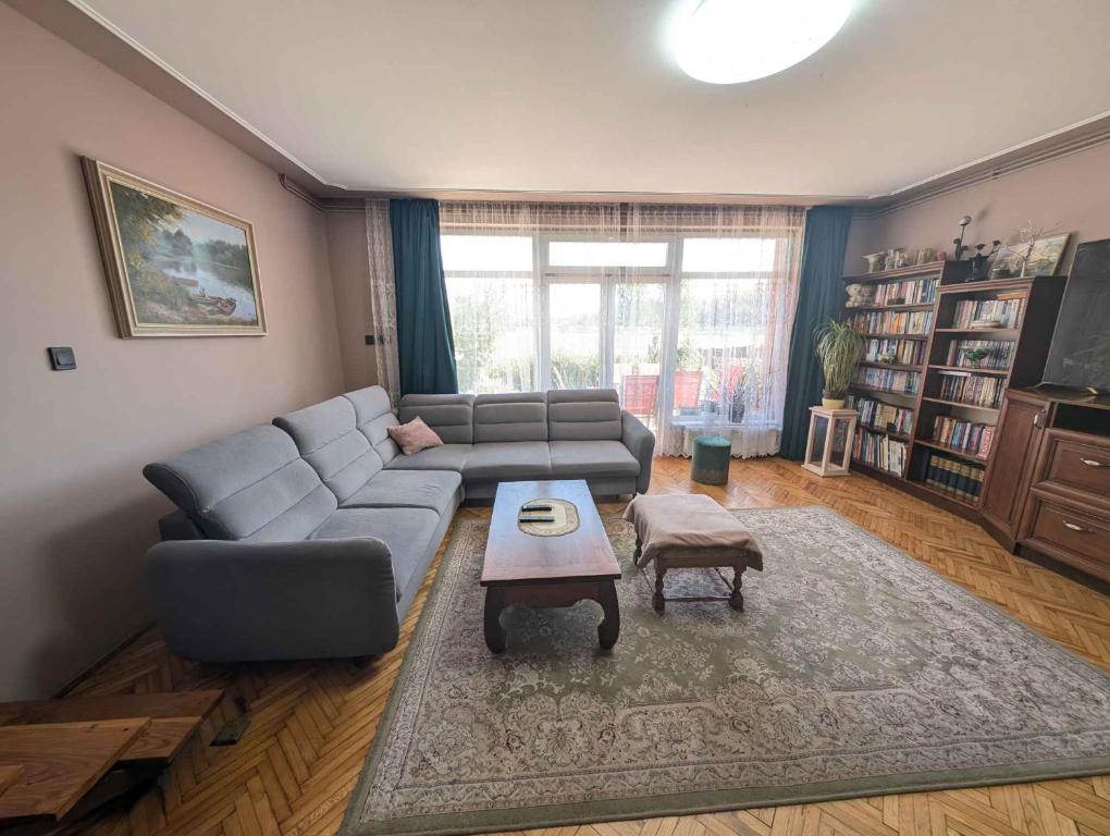 a living room with a couch and a table at Holiday home in Zamardi - Balaton 54796 in Zamárdi