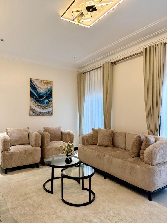 a living room with a couch and a table at Travelton Homes 2 in Gaba
