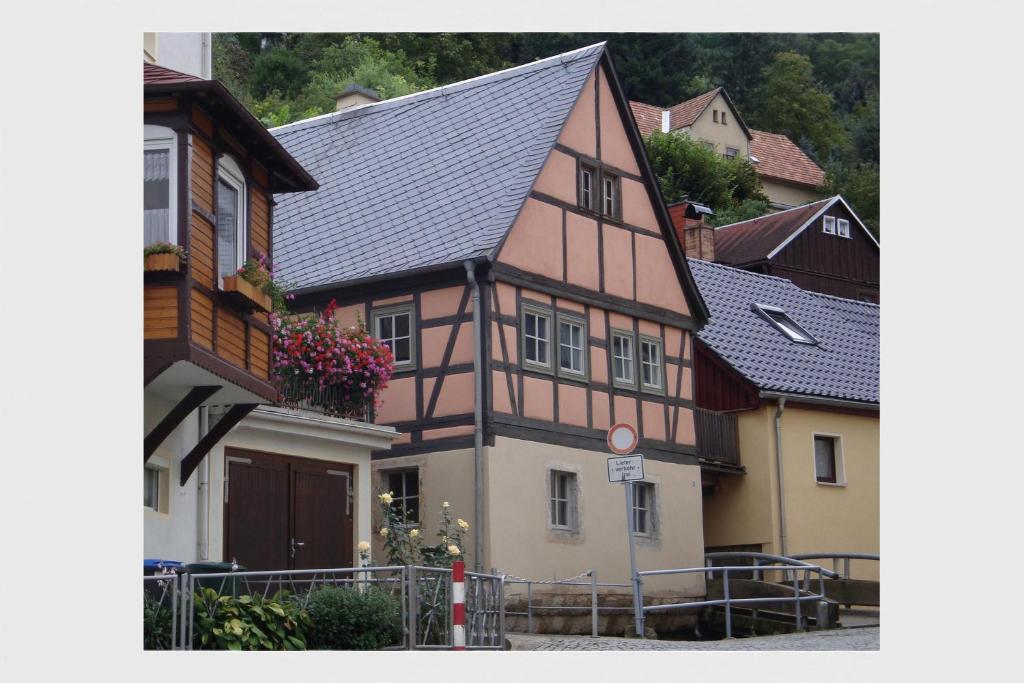 a building with a black roof in a town at Ferienhaus Altes Elbschifferhaus in Königstein an der Elbe