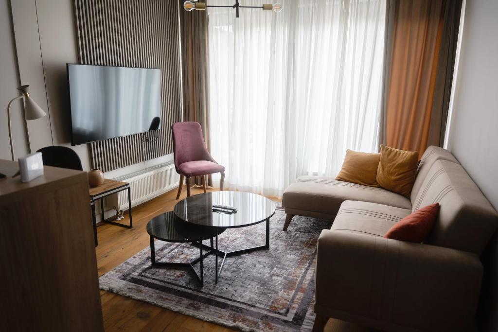a living room with a couch and a table at Apartment Nuve in Bjelašnica