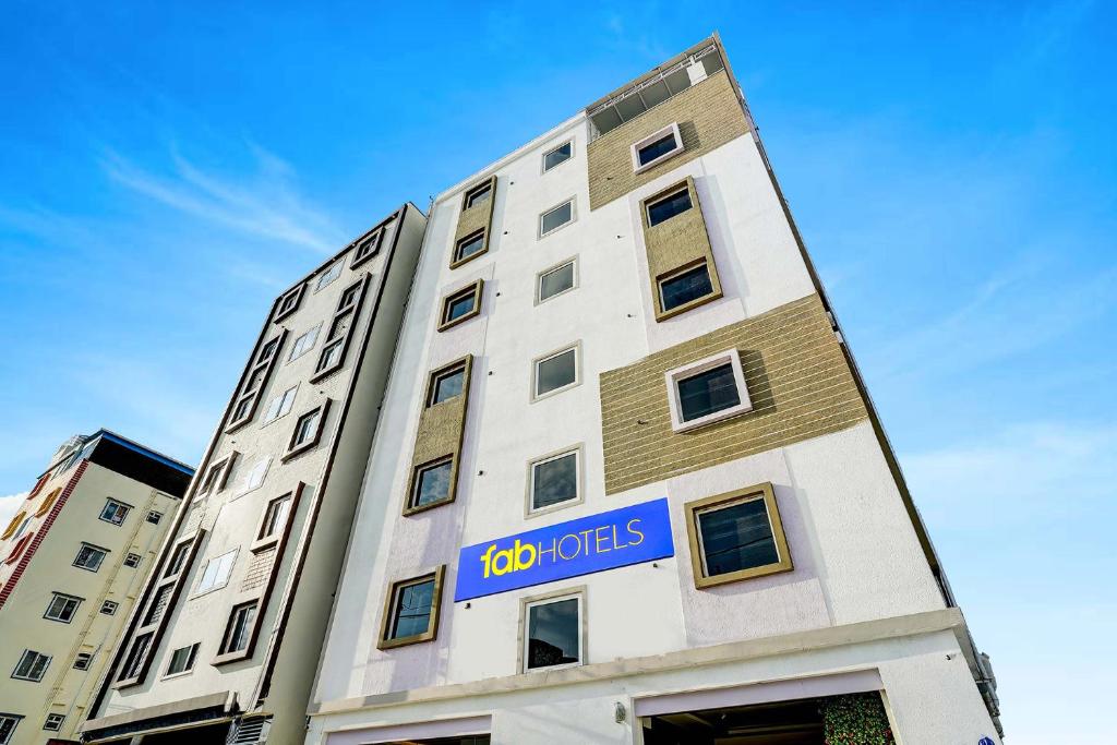 a building with a sign on the side of it at FabHotel Leon Square in Bengaluru