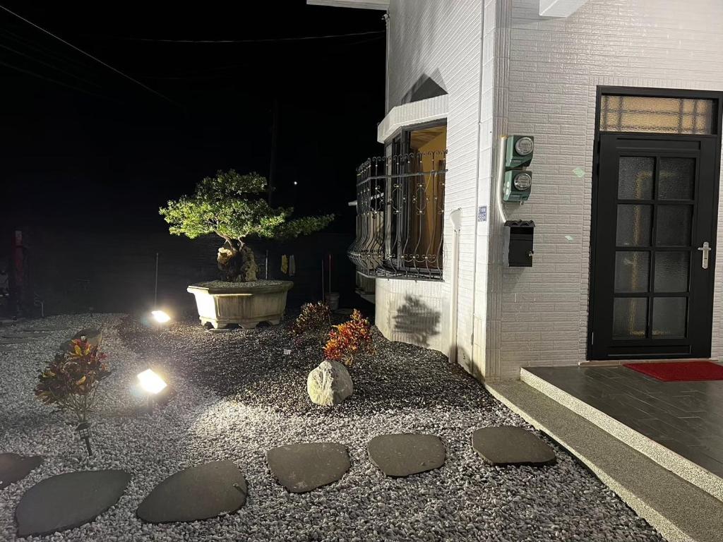 a house at night with a potted tree and a building at 哈娜家Villa 