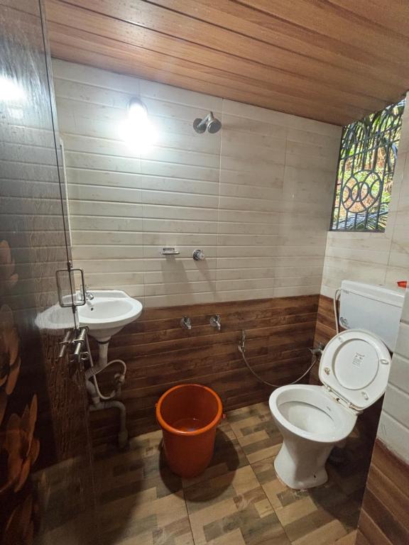 a bathroom with a toilet and a sink at Eden homes in Honāvar