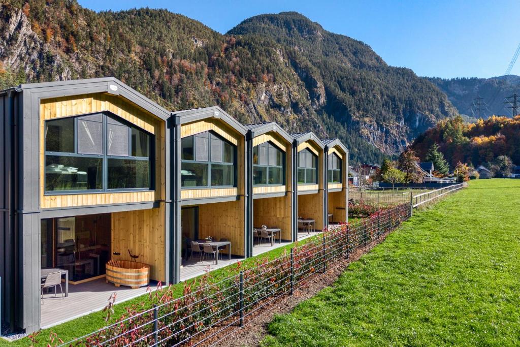 a house on a hill with mountains in the background at bsundrix Tiny Homes in Bludenz