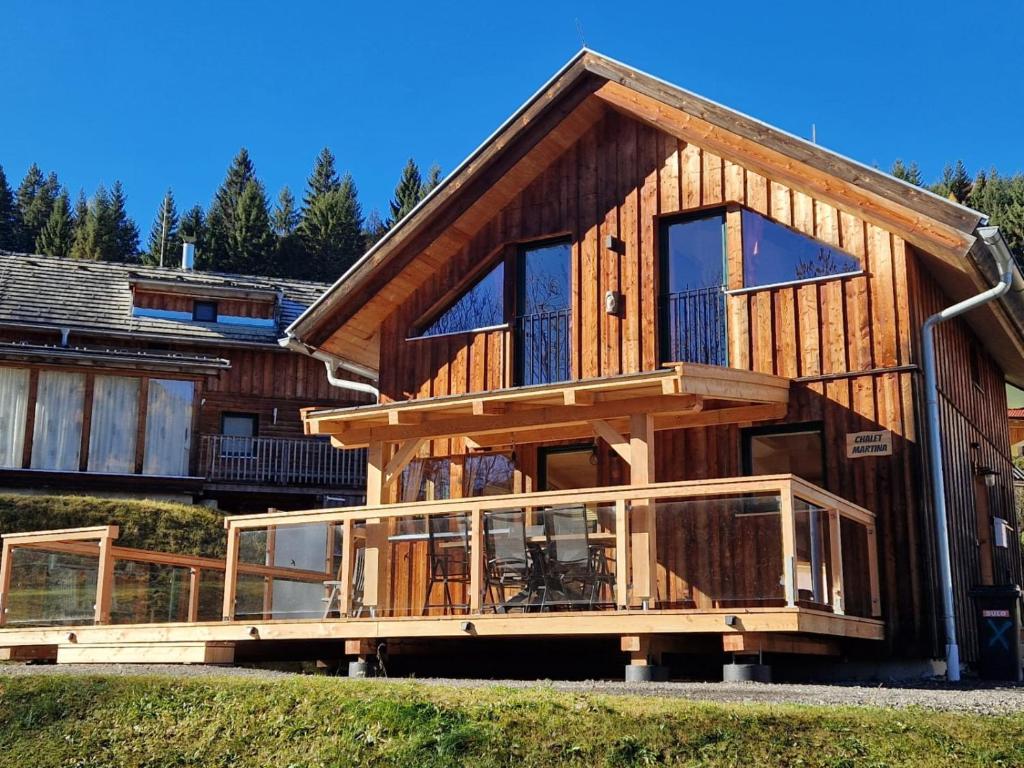 a large wooden house with a large deck at Chalet Martina in Stadl an der Mur