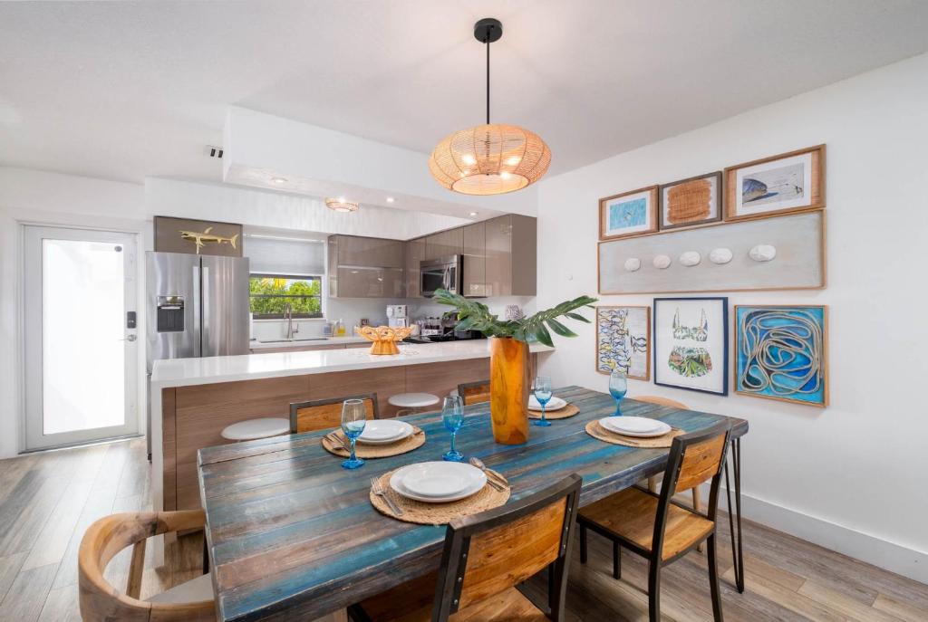 a dining room and kitchen with a wooden table and chairs at Saltwater Lagoon Front View, Marina, Kayaks in Key Largo