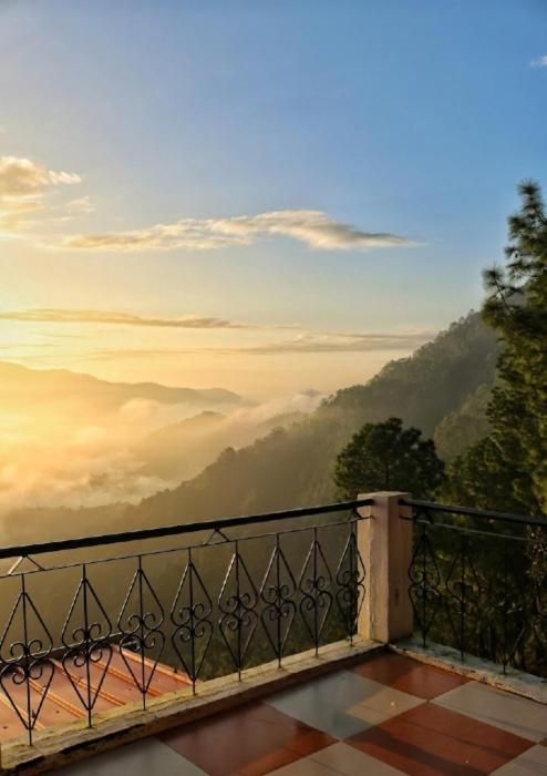 a balcony with a view of a misty mountain at Suncrest Trails Resort in Lansdowne