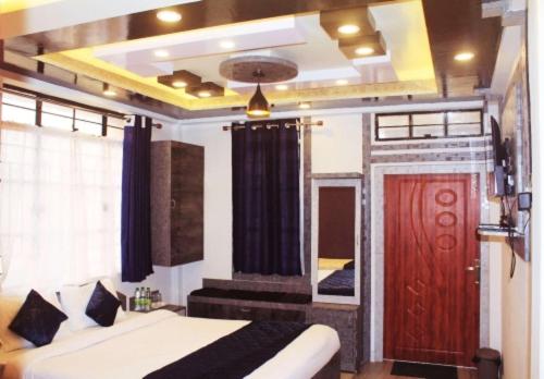 a bedroom with a bed and a red door at Sunny Ridge Homesty in Cherrapunji