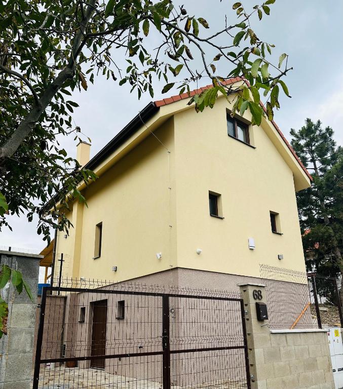 a building with a fence in front of it at Relax House Mšené-lázně in Loucká