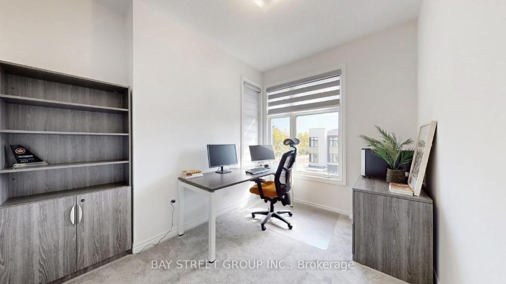 an office with a desk with a chair and a computer at Modern in Richmond Hill in Richmond Hill