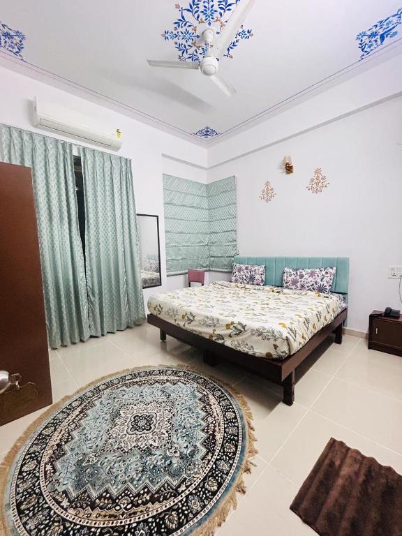 a bedroom with two beds and a rug at Hotel Lake Vista Stays in Udaipur