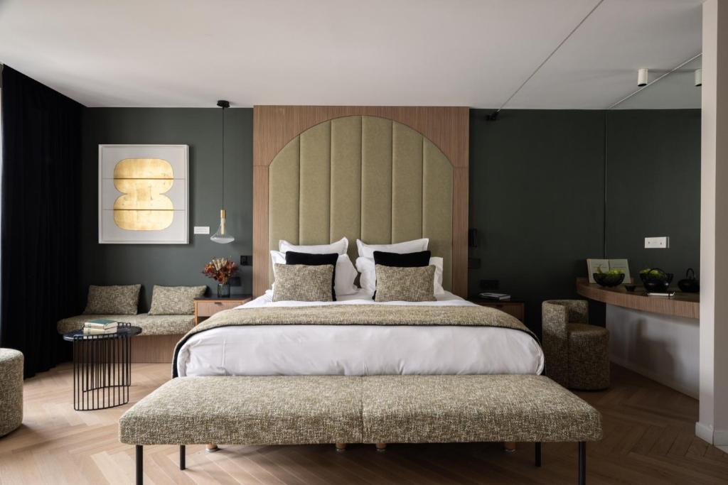 a bedroom with a large bed and two chairs at 1.75 Paris La Source in Paris