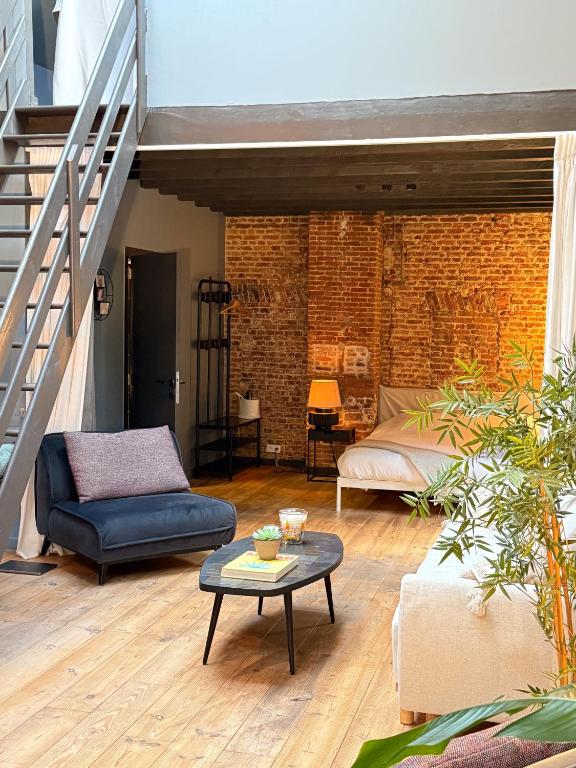 a living room with a couch and a table at NEW Central old town - Exclusive Residences in Antwerp