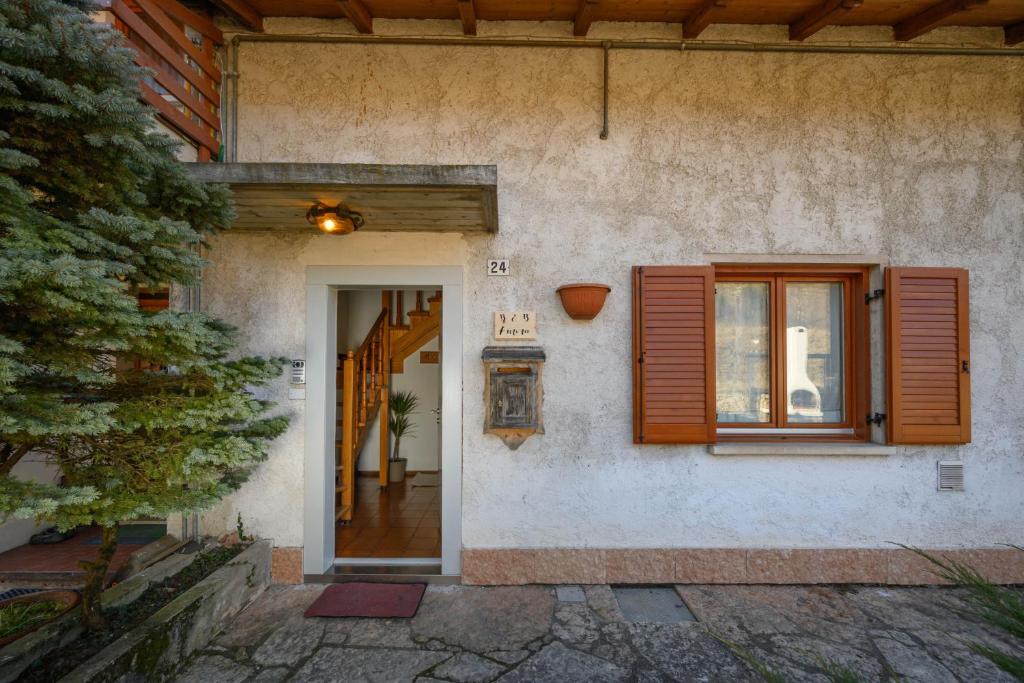 a house with a door and a window at bed an breakfast Aurora in Trento