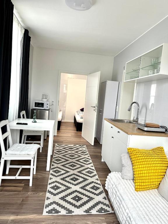 a kitchen and living room with a table and a couch at Miniapartment mit Bad und Kochnische in Dingolfing