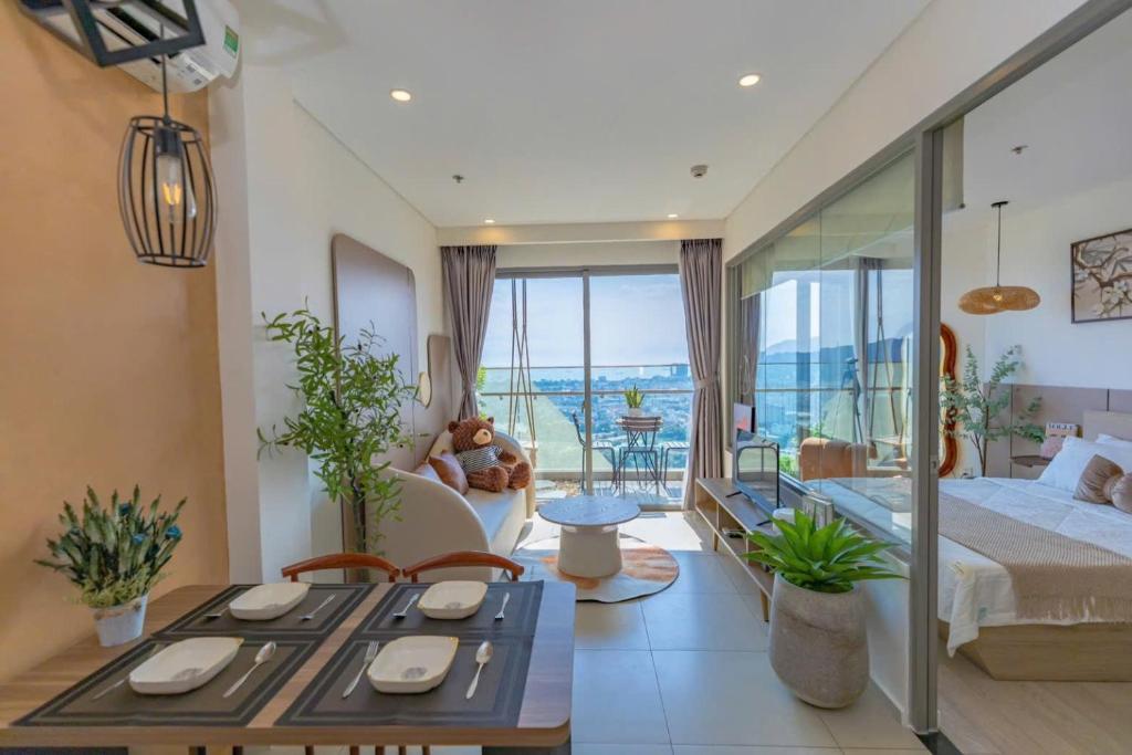 a bedroom with a king sized bed and a balcony at The Song Boutique Apartment in Vung Tau