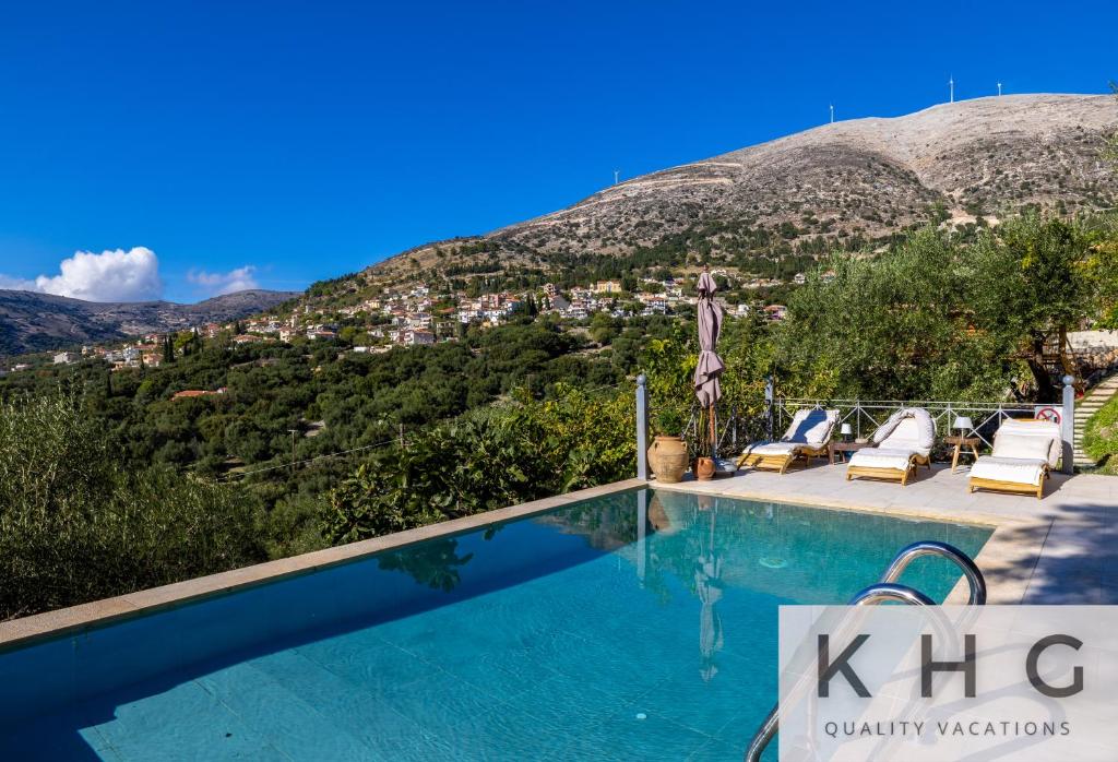a swimming pool with a view of a mountain at Anti-Pera Cottage with private pool in Dilinata village! in Argostoli