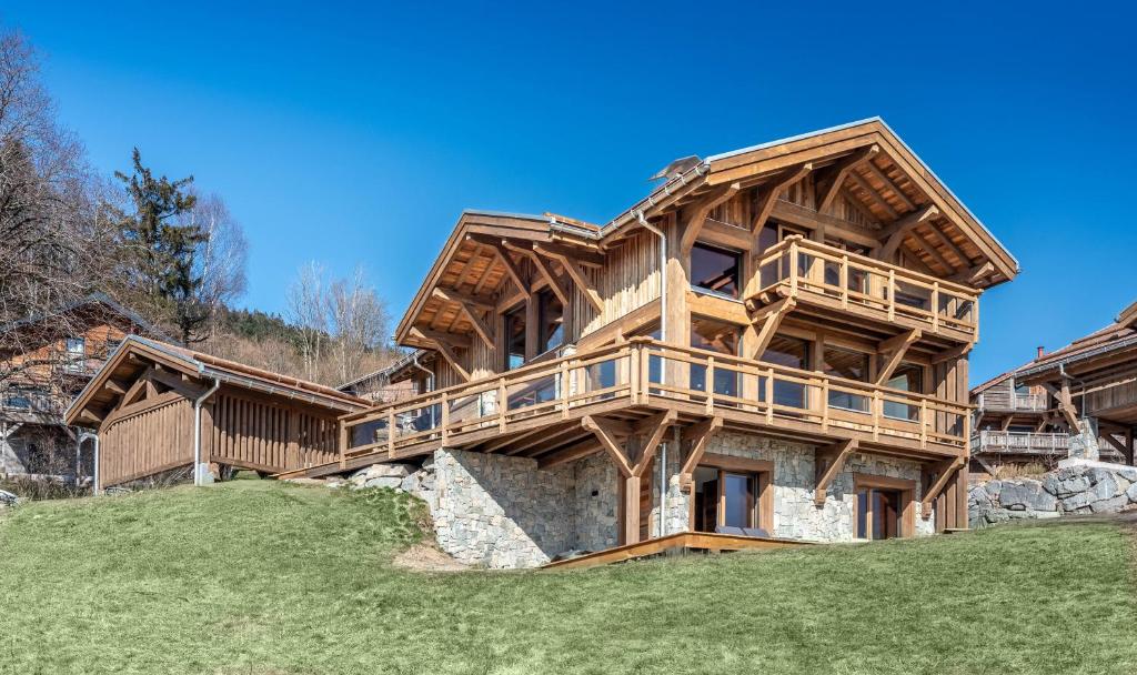 a large wooden house on top of a hill at Chalet de Scott, luxe avec spa et sauna in Gérardmer