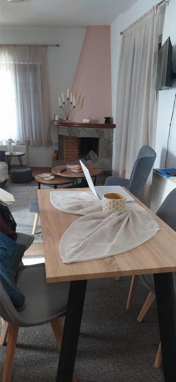 a living room with a wooden table with chairs at Αρσινόη apartments 4 in Arachova