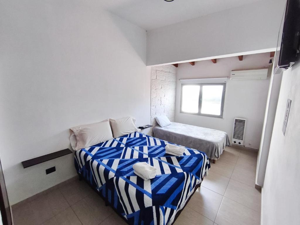 Ένα ή περισσότερα κρεβάτια σε δωμάτιο στο Aisha Alojamiento