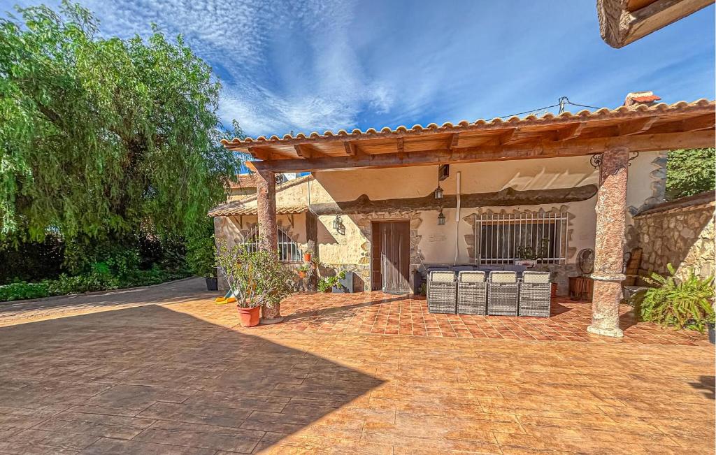 a patio of a house with a wooden pergola at Stunning Home In Mula in El Niño