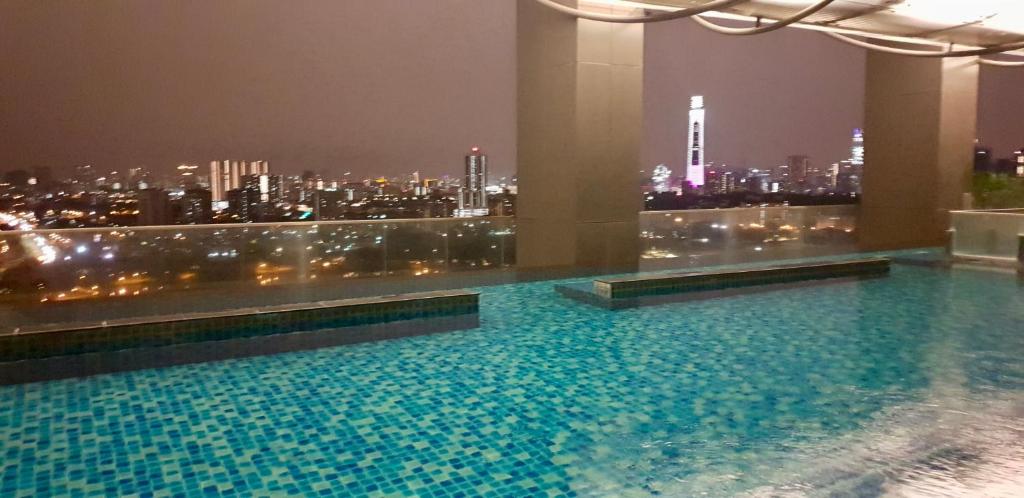 a swimming pool on top of a building with a city skyline at M City in Kuala Lumpur