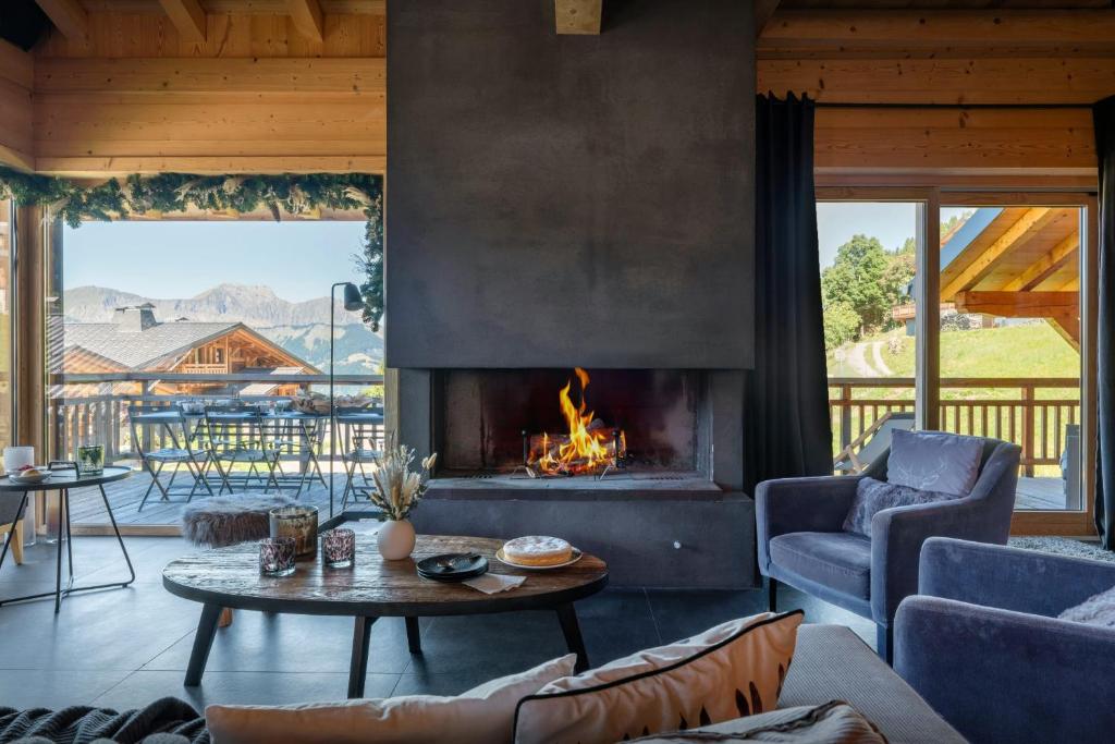a living room with a fireplace in a house at Chalet K - OVO Network in Chelou