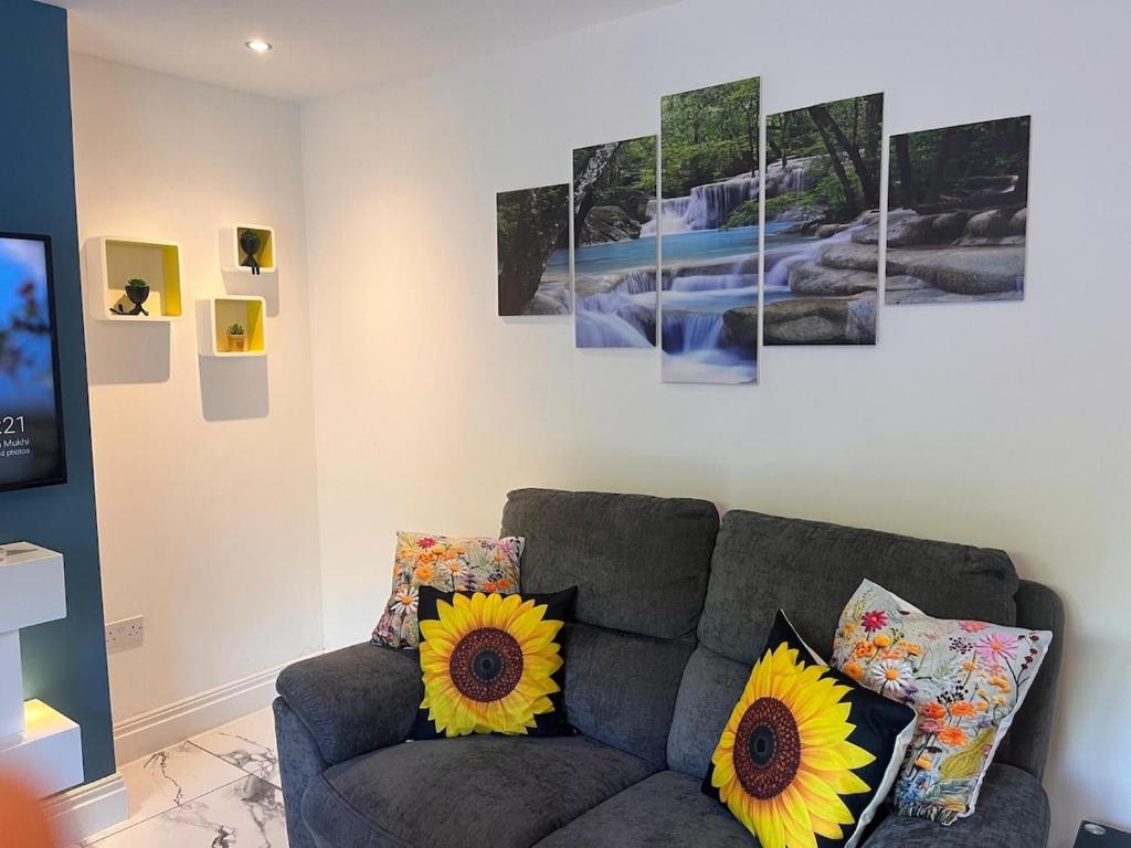 a living room with a couch with sunflowers on it at Paradise in Marston Green