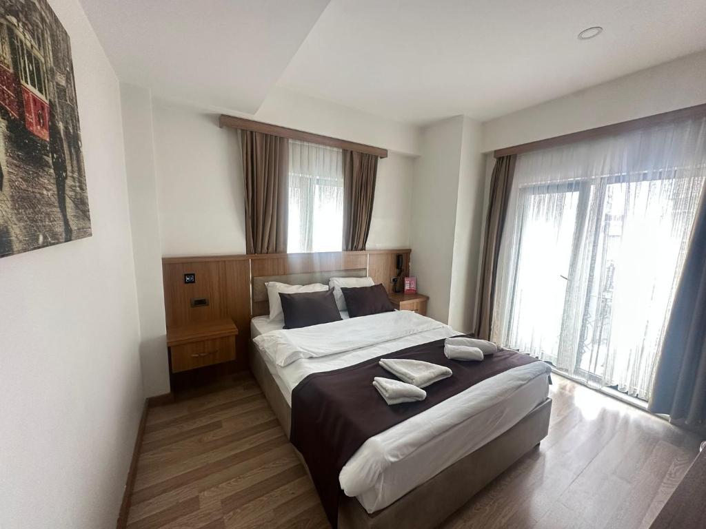a bedroom with a bed with two towels on it at Hotel La SERA in Istanbul