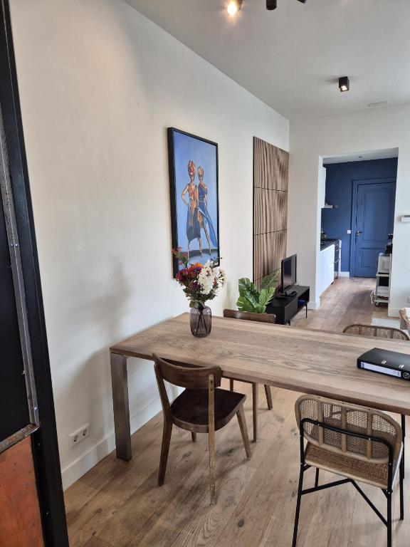 a dining room with a wooden table and chairs at Cozy apartment in Utrecht in Utrecht