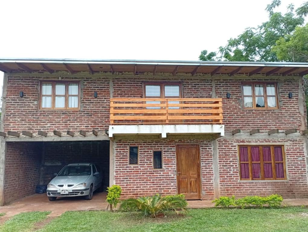 a car parked in front of a brick house at Serendipia in Oberá